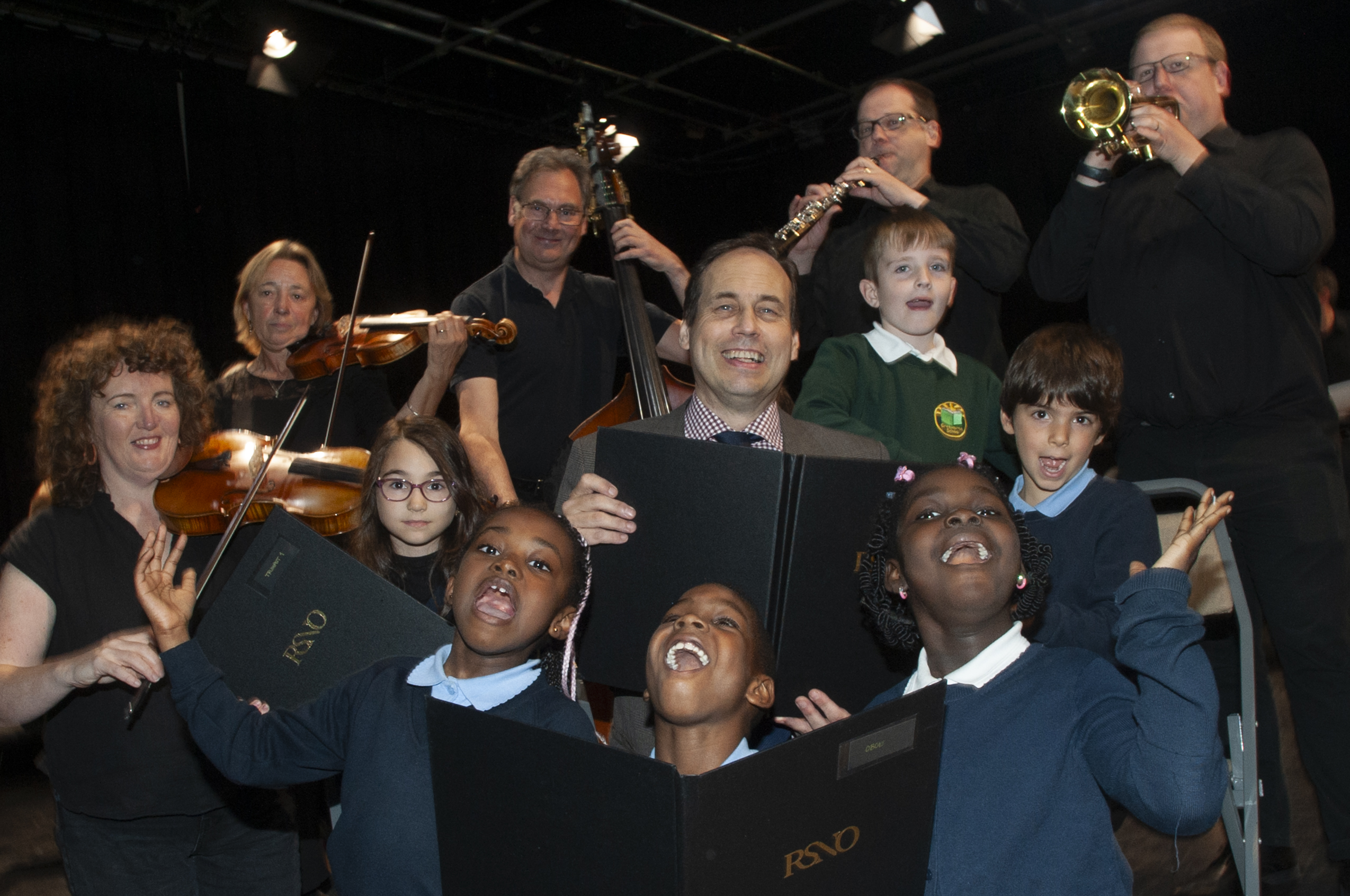 A picture of happy students and musicians holding instruments at the Lemon Tree.